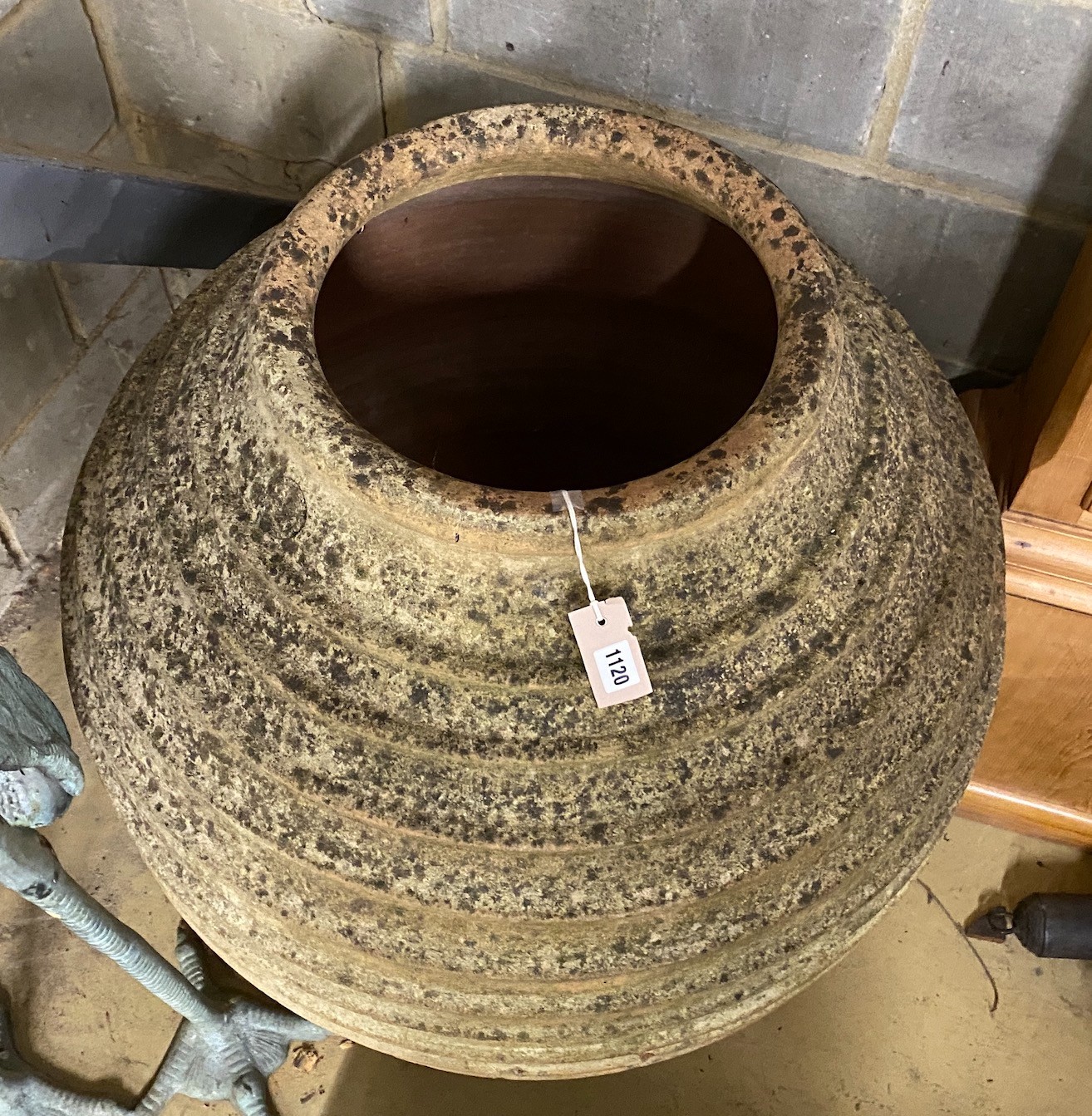 A large Grecian style circular earthenware oil jar (broken in two), height 84cm